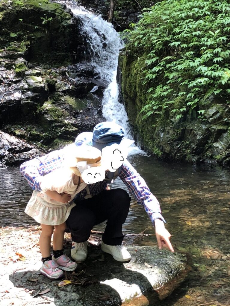 Parents and children playing near Akiyoshi Shiraito Waterfall